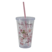 Clear tumbler with cherry blossom design and pink straw on a light gray background