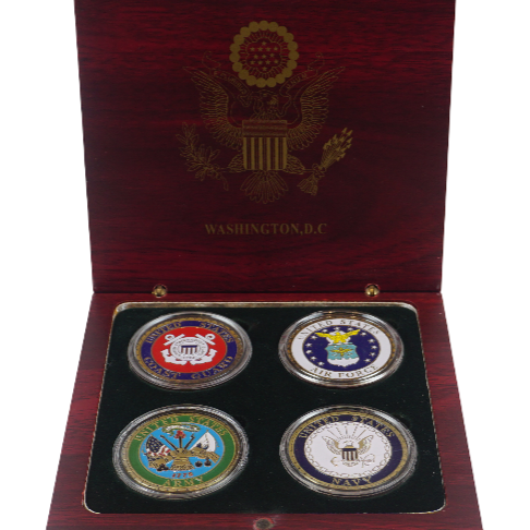 Set of four coins in a wooden box with a visible emblem on the lid.