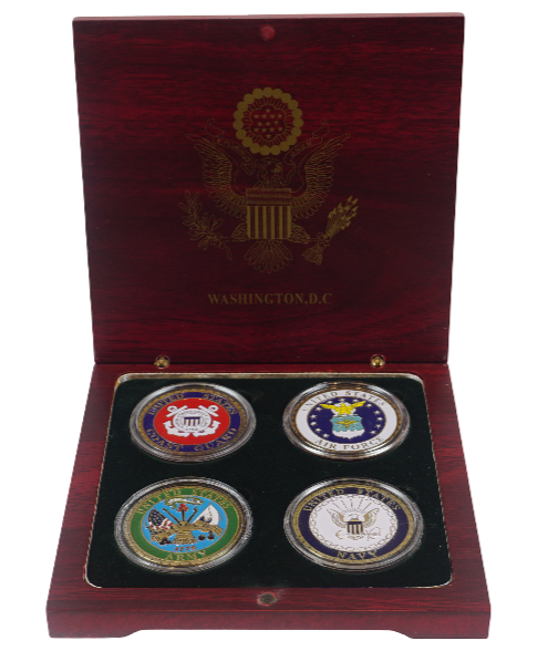 Set of four coins in a wooden box with a visible emblem on the lid.