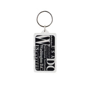 Rectangular Washington DC acrylic keychain with black background and white typography listing the White House, U.S. Capitol, Smithsonian Institution, and Lincoln Memorial.