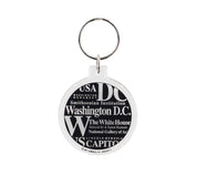 Black-and-white round Washington DC souvenir keychain featuring names of famous landmarks and museums in bold typography.