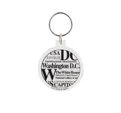 Round Washington DC acrylic keychain with black typography featuring the White House, U.S. Capitol, Smithsonian Institution, Lincoln Memorial, and Washington Monument.