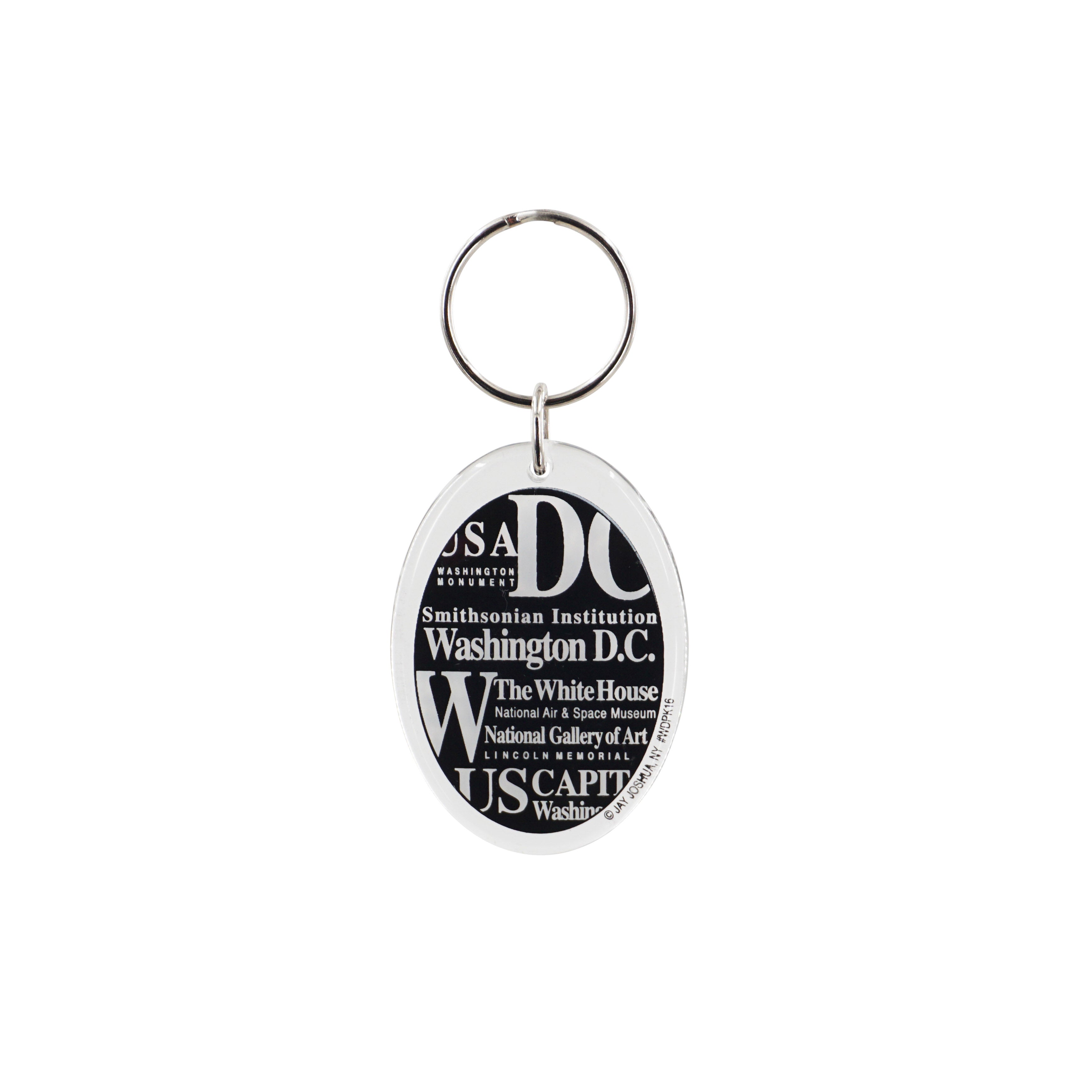 Oval Washington DC souvenir keychain with black-and-white typography featuring the White House, U.S. Capitol, Smithsonian Institution, Lincoln Memorial, and Washington Monument.
