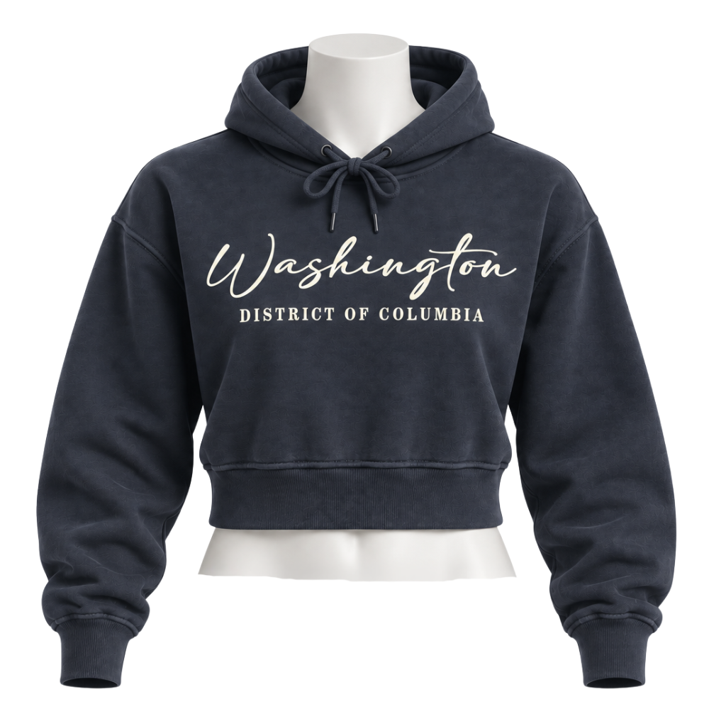 A cropped navy blue hoodie displayed on a white mannequin torso against a plain white background. The hoodie features the words 'Washington' in a white cursive font and 'DISTRICT OF COLUMBIA' in a white block font on the chest.