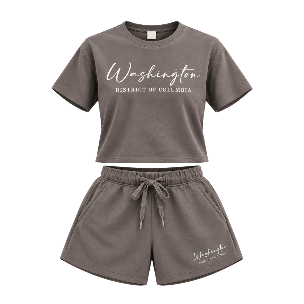 A two-piece' loungewear set in a dark grayish-brown color, featuring a short-sleeve t-shirt and matching shorts. The t-shirt has 'Washington District of Columbia' printed in white across the chest, and the shorts have a matching print on the lower left leg.