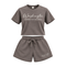 A two-piece' loungewear set in a dark grayish-brown color, featuring a short-sleeve t-shirt and matching shorts. The t-shirt has 'Washington District of Columbia' printed in white across the chest, and the shorts have a matching print on the lower left leg.