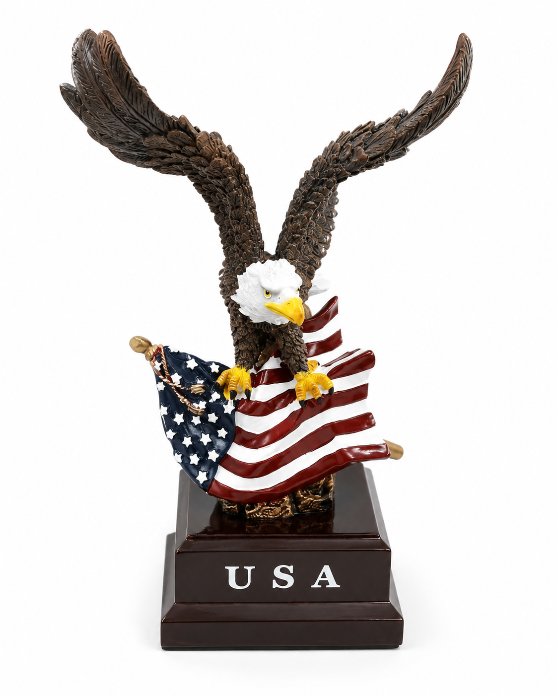 An eagle figurine with outstretched wings holding an American flag, mounted on a dark brown rectangular base engraved with 'USA'.