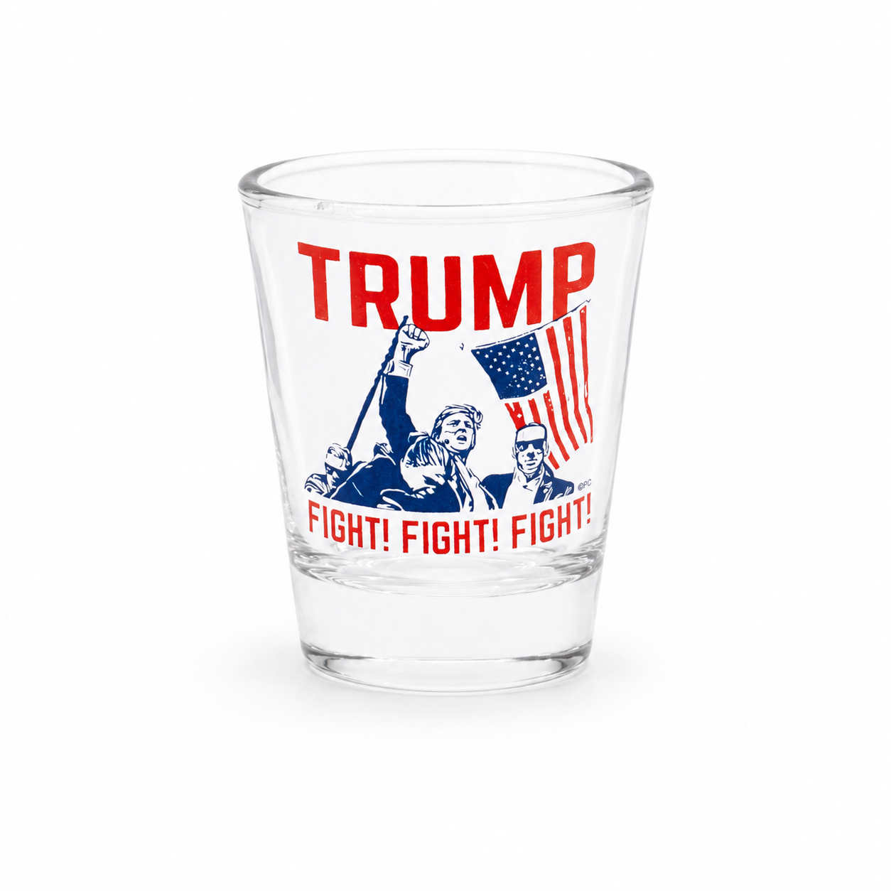 A clear glass shot glass featuring a red and blue political graphic with the word 'TRUMP' in large red letters, an American flag, and the phrase 'FIGHT! FIGHT! FIGHT!' in red, shown on a plain white background.
