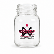A clear glass jar with a threaded neck and a printed graphic on the front featuring a pink and black moon design with the text 'MOONSHINE' and 'BEST CURE FOR AN AILING CONGRESS' on a white background.