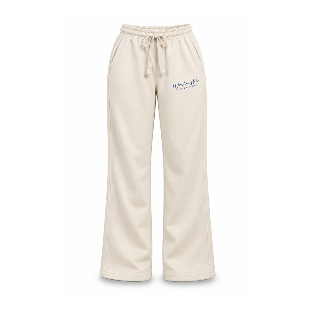 Cream wide-leg sweatpants with a drawstring waist and a small navy blue embroidered logo on the left thigh, shown against a plain white background.