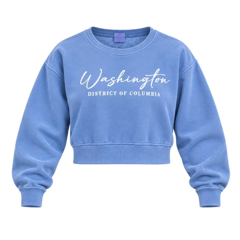 A light blue cropped crewneck sweatshirt with 'Washington District of Columbia' printed in white across the chest, displayed on a clean white background.