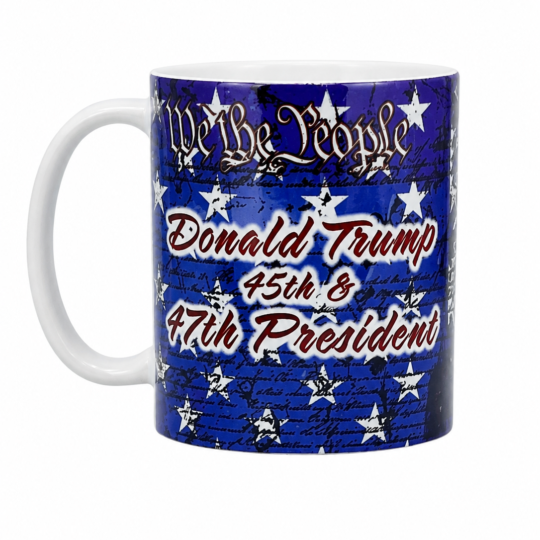 A white ceramic mug featuring a blue and white patriotic graphic with the text 'Donald Trump 45th & 47th President' and 'We the People' with stars.