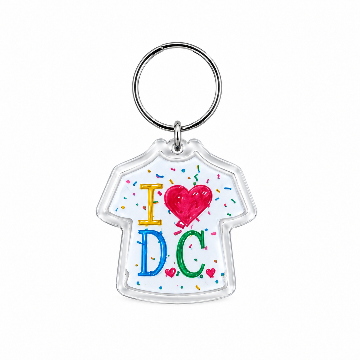 A clear acrylic keychain shaped like a white t-shirt with 'I' in yellow, a red heart, and 'DC' in blue and green, surrounded by colorful confetti, attached to a silver metal key ring on a white background.