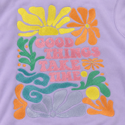 A close-up of a lavender purple garment featuring colorful embroidered retro floral designs and the text 'GOOD THINGS TAKE TIME' in pink.