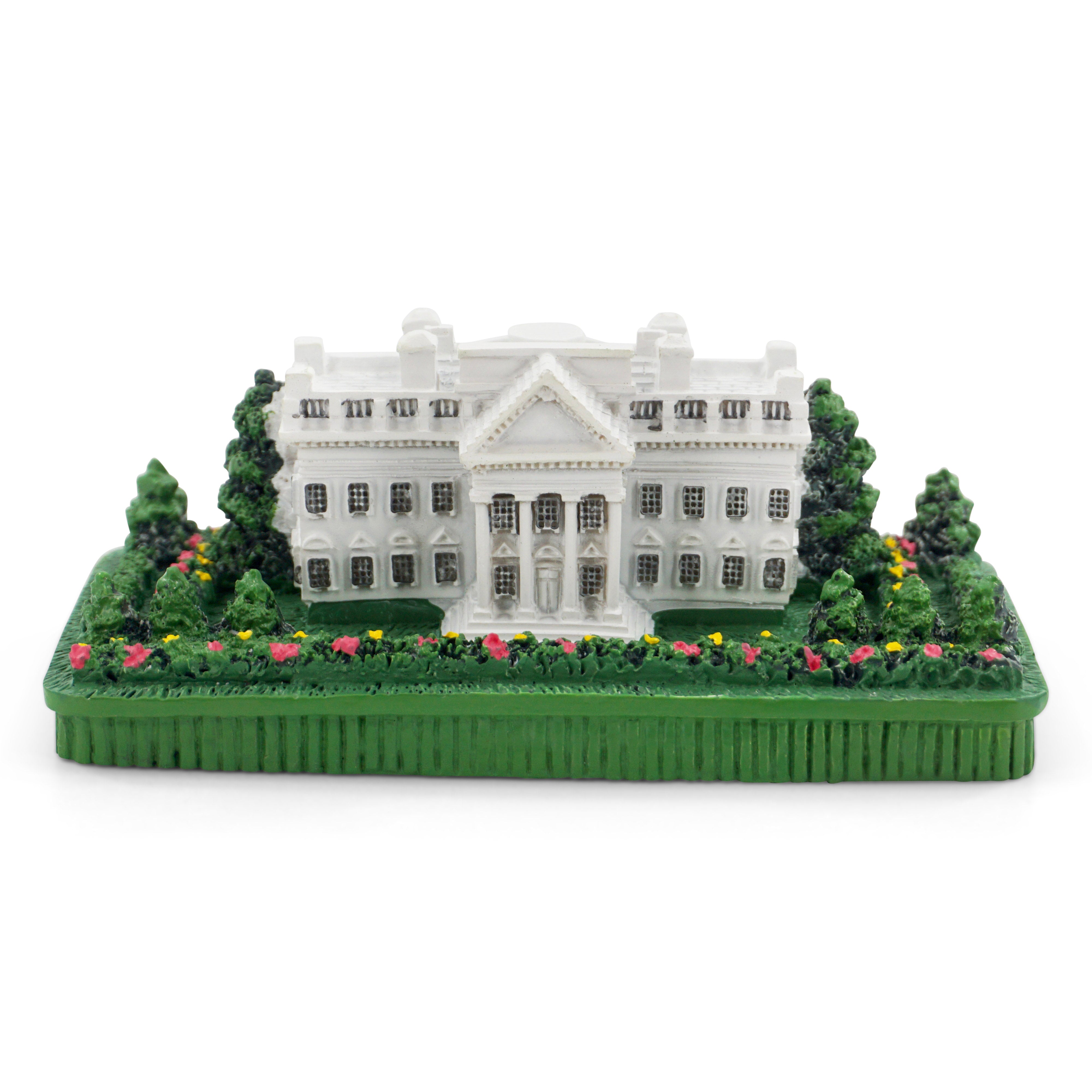 Model of a white House building with greenery on a white background