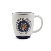 A white ceramic coffee mug with the official Presidential Seal printed on the side and the words 'Washington' on the handle.