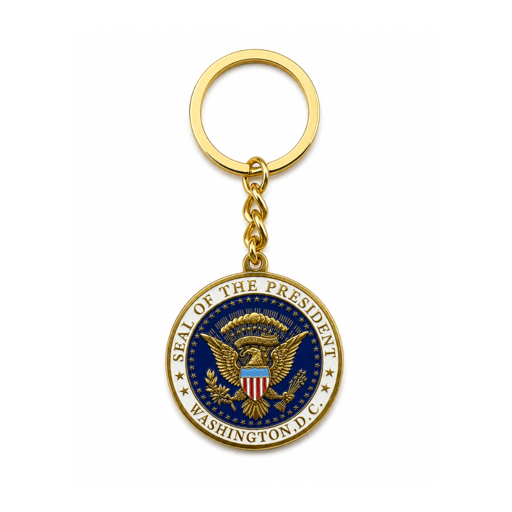 A gold-colored keychain featuring the Seal of the President of the United States in the center, suspended from a gold split ring on a clean white background.