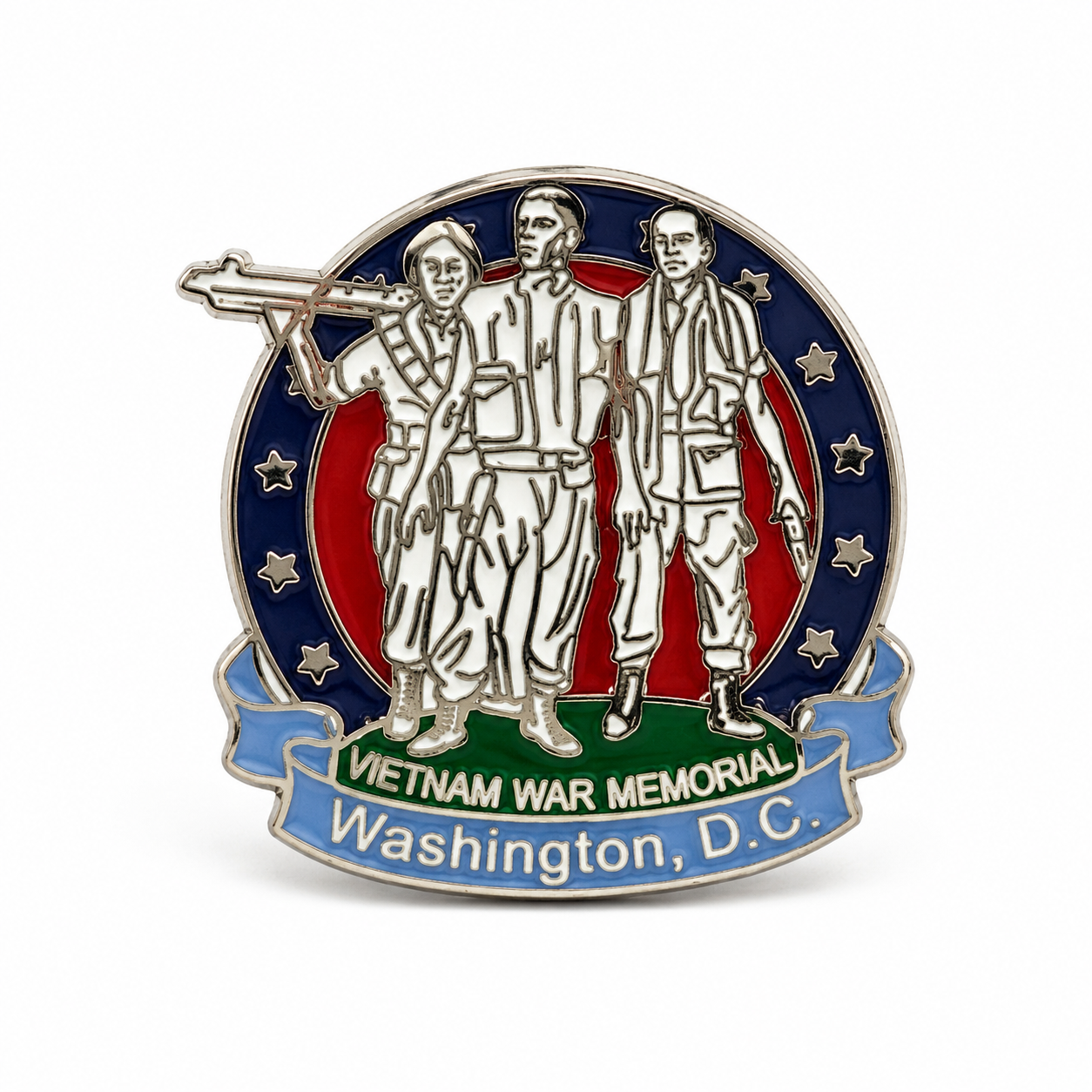 A circular Vietnam War Memorial lapel pin featuring three soldiers in silver-tone metal, with a blue outer ring of stars, a red center, and a blue ribbon banner reading 'VIETNAM WAR MEMORIAL Washington, D.C.