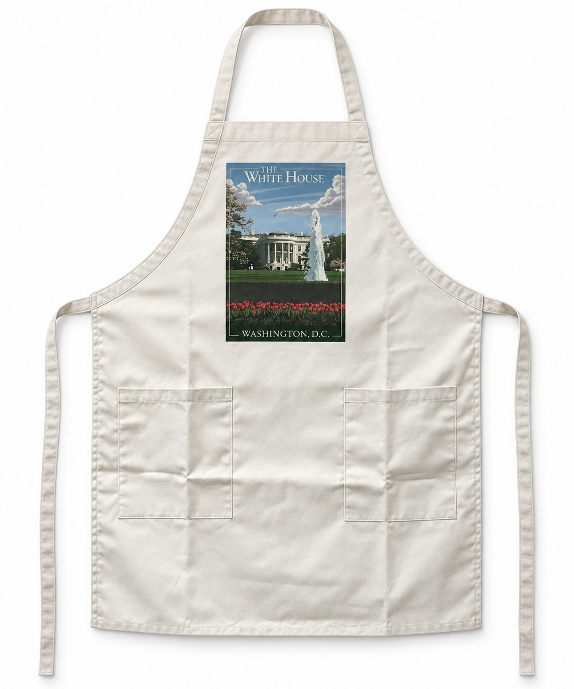 An off-white bib apron with two front pockets and neck strap, featuring a rectangular graphic print of the White House and its fountain on the chest.