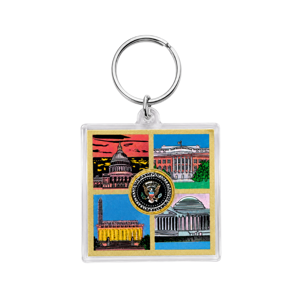 A square acrylic keychain featuring a colorful collage of US government buildings, including the Capitol, White House, Supreme Court, and Library of Congress, with the Presidential Seal in the center. The keychain has a clear plastic body, a silver metal key ring, and a gold-toned border.