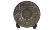 A large metal pewter plate with a detailed U.S. Seal and various iconic landmarks of Washington, D.C.