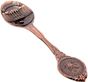 A bronze-colored copper collectible spoon with the White House design and a U.S. flag emblem in the center.